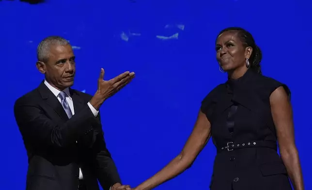 Former President Barack Obama hugs former first lady Michelle Obama as he is introduced during the Democratic National Convention Tuesday, Aug. 20, 2024, in Chicago. (AP Photo/Brynn Anderson)