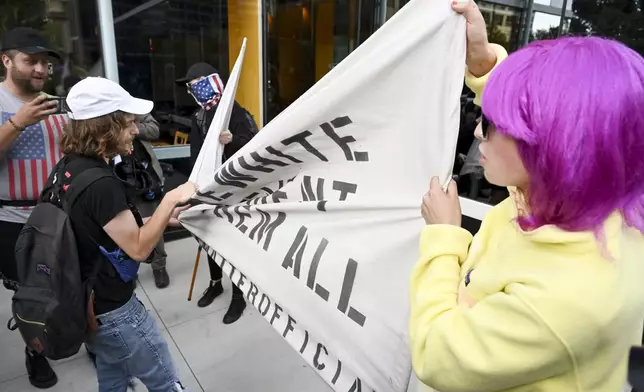 Demonstrators clash with counter protesters near the Israeli Consulate during the Democratic National Convention Tuesday, Aug. 20, 2024, in Chicago. (AP Photo/Noah Berger)