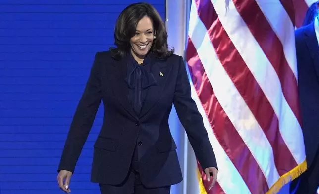 Democratic presidential nominee Vice President Kamala Harris walks on stage to speak during the Democratic National Convention Thursday, Aug. 22, 2024, in Chicago. (AP Photo/J. Scott Applewhite)