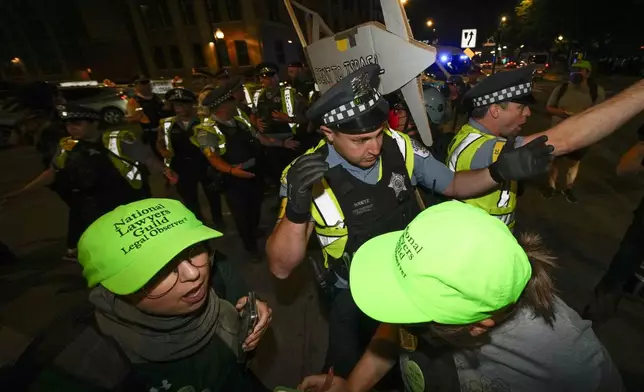 Police move protesters during a demonstration near the Democratic National Convention Thursday, Aug. 22, 2024, in Chicago. (AP Photo/Julio Cortez)