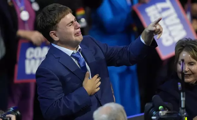 Gus Walz cries as his father Democratic vice presidential nominee Minnesota Gov. Tim Walz speaks during the Democratic National Convention Wednesday, Aug. 21, 2024, in Chicago. (AP Photo/Charles Rex Arbogast)