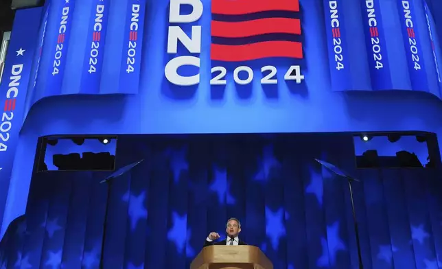 Adam Kinzinger, former member of the U.S. House of Representatives from Illinois speaks during the Democratic National Convention Thursday, Aug. 22, 2024, in Chicago. (AP Photo/Paul Sancya)