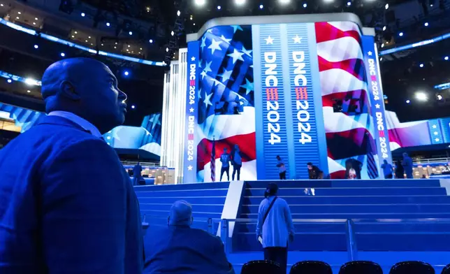 Jaime Harrison, Democratic National Committee chair, watches as preparations are made before the upcoming Democratic National Convention, Thursday, Aug. 15, 2024, in Chicago. (AP Photo/Alex Brandon)