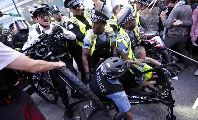 Demonstrators clash with police near the Israeli Consulate during the Democratic National Convention Tuesday, Aug. 20, 2024, in Chicago. (AP Photo/Alex Brandon)