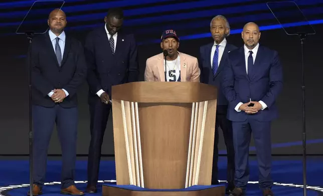 Korey Wise, center, joined by fellow members of The Exonerated Five, Kevin Richardson, from left, Yusef Salaam, and Raymond Santana, right, along with Rev. Al Sharpton, second right, speak during the Democratic National Convention Thursday, Aug. 22, 2024, in Chicago. (AP Photo/J. Scott Applewhite)