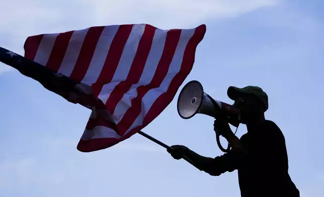 A counter protester yells at demonstrators during a rally near the Democratic National Convention Thursday, Aug. 22, 2024, in Chicago. (AP Photo/Julio Cortez)