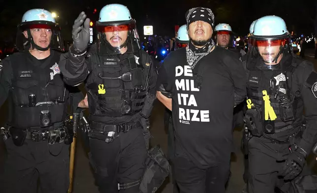 Police move protesters during a demonstration near the Democratic National Convention Thursday, Aug. 22, 2024, in Chicago. (AP Photo/Noah Berger)