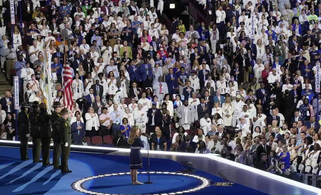 People in the crowd wear white during the Pledge of Alliegence during the Democratic National Convention Thursday, Aug. 22, 2024, in Chicago. (AP Photo/Morry Gash)