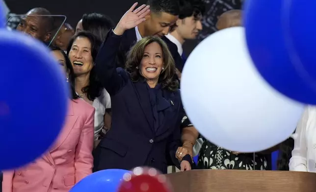 Democratic presidential nominee Vice President Kamala Harris waves surrounded by balloons at the Democratic National Convention Thursday, Aug. 22, 2024, in Chicago. (AP Photo/J. Scott Applewhite)