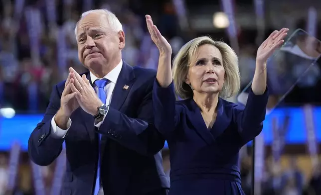 Democratic vice presidential nominee Minnesota Gov. Tim Walz and wife Gwen react during the Democratic National Convention Wednesday, Aug. 21, 2024, in Chicago. (AP Photo/Paul Sancya)