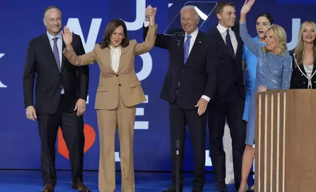 Democratic presidential nominee Vice President Kamala Harris and President Joe Biden on stage with second gentleman Doug Emhoff, left, and first lady Jill Biden, right, during the Democratic National Convention Monday, Aug. 19, 2024, in Chicago. (AP Photo/J. Scott Applewhite)