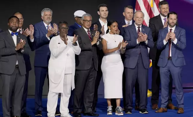 Democratic veterans serving in local, state and federal levels of government stand alongside Rep. Ruben Gallego, D-Ariz., during the Democratic National Convention Thursday, Aug. 22, 2024, in Chicago. (AP Photo/J. Scott Applewhite)