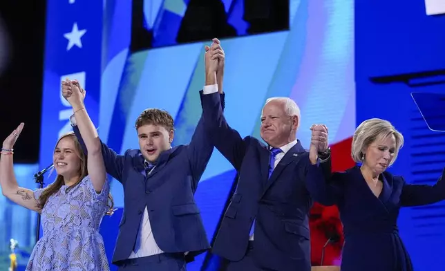 Democratic vice presidential nominee Minnesota Gov. Tim Walz celebrates with his family during the Democratic National Convention Wednesday, Aug. 21, 2024, in Chicago. (AP Photo/Brynn Anderson)