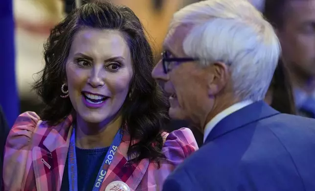 Michigan Gov. Gretchen Whitmer talks to Wisconsin Gov. Tony Evers during the Democratic National Convention Tuesday, Aug. 20, 2024, in Chicago. (AP Photo/Charles Rex Arbogast)