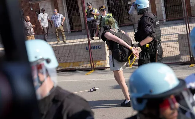 Police take a protester into custody after a fence surrounding United Center was knock down at the Democratic National Convention after a march Monday, Aug. 19, 2024, in Chicago. (AP Photo/Alex Brandon)