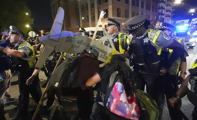 Police move protesters during a demonstration near the Democratic National Convention Thursday, Aug. 22, 2024, in Chicago. (AP Photo/Alex Brandon)