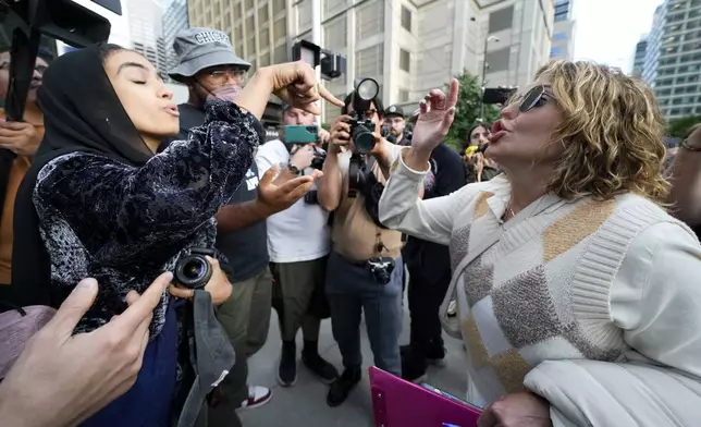 A demonstrator and a counter protester argue near the Israeli Consulate during the Democratic National Convention Tuesday, Aug. 20, 2024, in Chicago. (AP Photo/Julio Cortez)