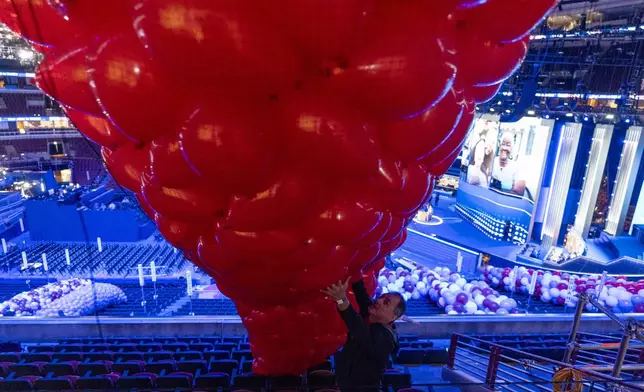 Tony Popelka guides a bag of balloons as preparations are made before the upcoming Democratic National Convention, Thursday, Aug. 15, 2024, in Chicago. (AP Photo/Alex Brandon)