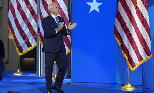 Democratic vice presidential nominee Minnesota Gov. Tim Walz walks on stage to speak during the Democratic National Convention Wednesday, Aug. 21, 2024, in Chicago. (AP Photo/J. Scott Applewhite)