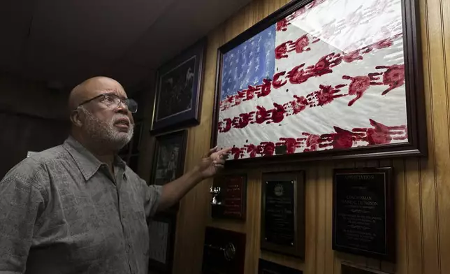 Rep. Bennie Thompson, D-Miss., shows artwork, completed by Elementary School students, from his office on Wednesday, Aug. 14, 2024, in Bolton, Miss. (AP Photo/Stephen Smith)
