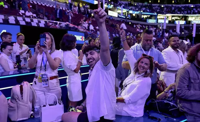 Content creators cheer from their position on the floor before the final night of the Democratic National Convention Thursday, Aug. 22, 2024, in Chicago. (AP Photo/Charles Rex Arbogast)