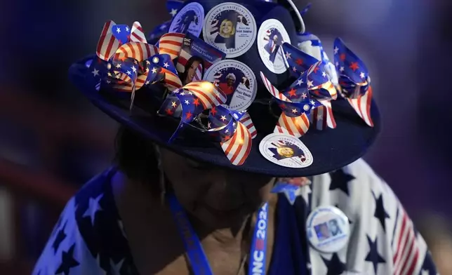 A member of the Mississippi delegation makes her way to her seat during the Democratic National Convention Monday, Aug. 19, 2024, in Chicago. (AP Photo/Charles Rex Arbogast)