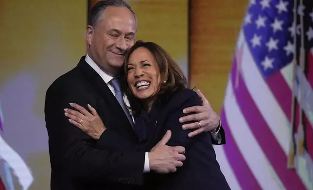 Democratic presidential nominee Vice President Kamala Harris hugs Second gentleman Douglas Emhoff after the nomination during the Democratic National Convention Thursday, Aug. 22, 2024, in Chicago. (AP Photo/Brynn Anderson)