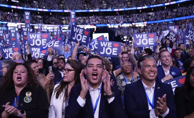 Delegates cheer as President Joe Biden speaks during the Democratic National Convention Monday, Aug. 19, 2024, in Chicago. (AP Photo/Paul Sancya)