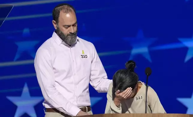 Jon Polin, left, and Rachel Goldberg, parents of Hersh Goldberg-Polin, speak on stage during the Democratic National Convention Wednesday, Aug. 21, 2024, in Chicago. (AP Photo/J. Scott Applewhite)