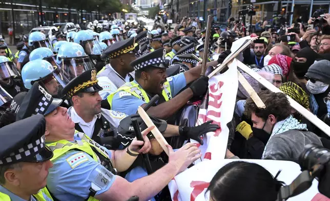 Demonstrators clash with police near the Israeli Consulate during the Democratic National Convention Tuesday, Aug. 20, 2024, in Chicago. (AP Photo/Noah Berger)