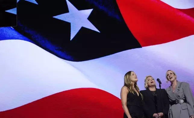 Emily Robison, from left, Natalie Maines and Martie Maguire, of The Chicks, sing the national anthem during the Democratic National Convention Thursday, Aug. 22, 2024, in Chicago. (AP Photo/Brynn Anderson)