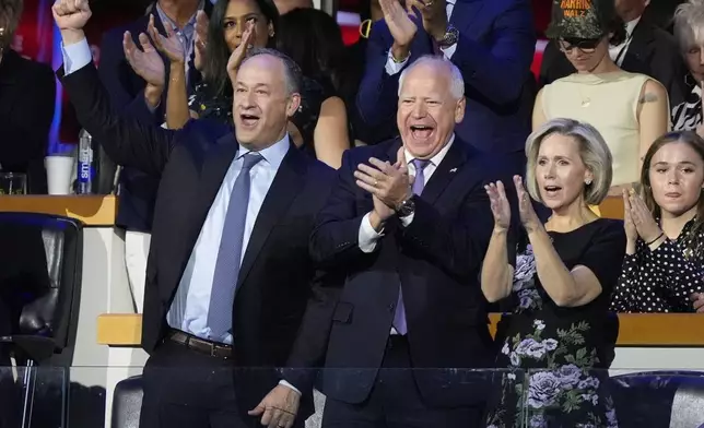 Second Gentalman Douglas Emhoff, Democratic vice presidential nominee Minnesota Gov. Tim Walz and wife Gwen cheer for Democratic presidential nominee Vice President Kamala Harris during the Democratic National Convention Monday, Aug. 19, 2024, in Chicago. (AP Photo/Charles Rex Arbogast)