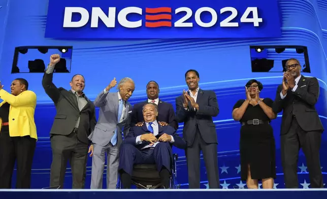 Al Sharpton, left, talks to Rev. Jesse Jackson gesture during the Democratic National Convention Monday, Aug. 19, 2024, in Chicago. (AP Photo/Paul Sancya)