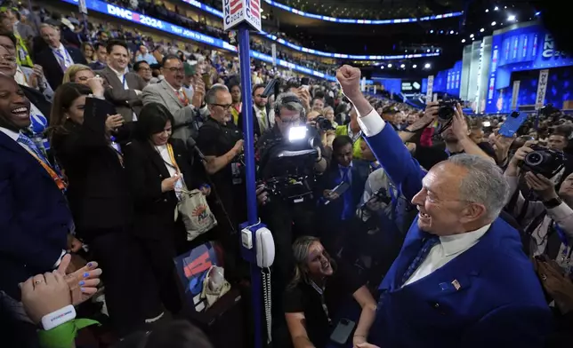 Sen. Chuck Schumer, D-N.Y., pumps his fist as he walks on the convention floor during the Democratic National Convention Tuesday, Aug. 20, 2024, in Chicago. (AP Photo/Paul Sancya)