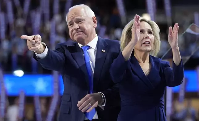 Democratic vice presidential nominee Minnesota Gov. Tim Walz and wife Gwen react during the Democratic National Convention Wednesday, Aug. 21, 2024, in Chicago. (AP Photo/Paul Sancya)