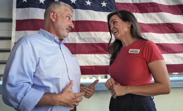 Whitney Fox, Democratic candidate for Florida's 13th congressional district, right, talks to former St. Petersburg Mayor Rick Kriseman during her primary night election watch party Tuesday, Aug. 20, 2024, in Dunedin, Fla. (AP Photo/Chris O'Meara)