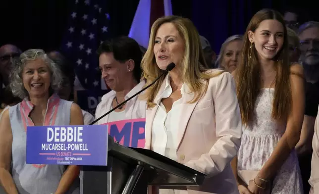 Former U.S. Rep. Debbie Mucarsel-Powell, center, speaks after winning the Democratic nomination for U.S. Senate, Tuesday, Aug. 20, 2024, in Coral Gables, Fla. (AP Photo/Marta Lavandier)