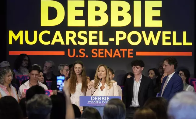 Former U.S. Rep. Debbie Mucarsel-Powell, center, speaks after winning the Democratic nomination for U.S. Senate, Tuesday, Aug. 20, 2024, in Coral Gables, Fla. (AP Photo/Marta Lavandier)