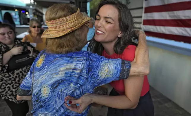 Whitney Fox, Democratic candidate for Florida's 13th congressional district, right, hugs a supporter during her primary night election watch party Tuesday, Aug. 20, 2024, in Dunedin, Fla. (AP Photo/Chris O'Meara)