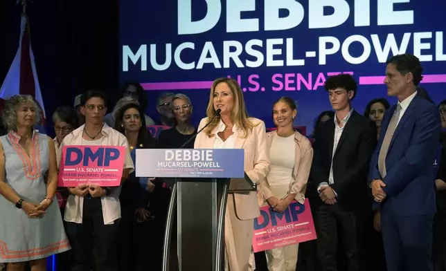 Former U.S. Rep. Debbie Mucarsel-Powell, center, speaks after winning the Democratic nomination for U.S. Senate, Tuesday, Aug. 20, 2024, in Coral Gables, Fla. (AP Photo/Marta Lavandier)