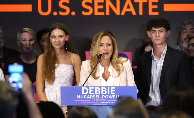 Former U.S. Rep. Debbie Mucarsel-Powell, center, speaks after winning the Democratic nomination for U.S. Senate, Tuesday, Aug. 20, 2024, in Coral Gables, Fla. (AP Photo/Marta Lavandier)