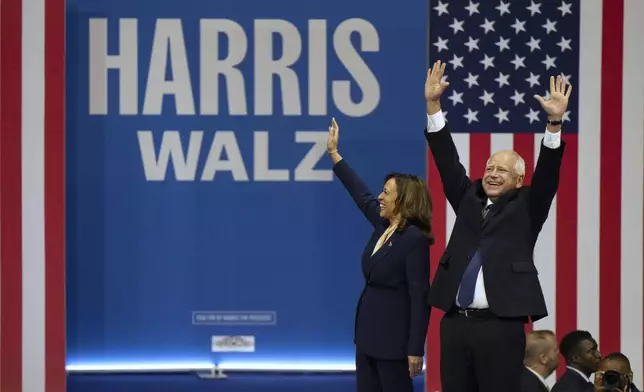 Democratic presidential nominee Vice President Kamala Harris and her running mate Minnesota Gov. Tim Walz arrive for a campaign rally in Philadelphia, Tuesday, Aug. 6, 2024. (AP Photo/Joe Lamberti)