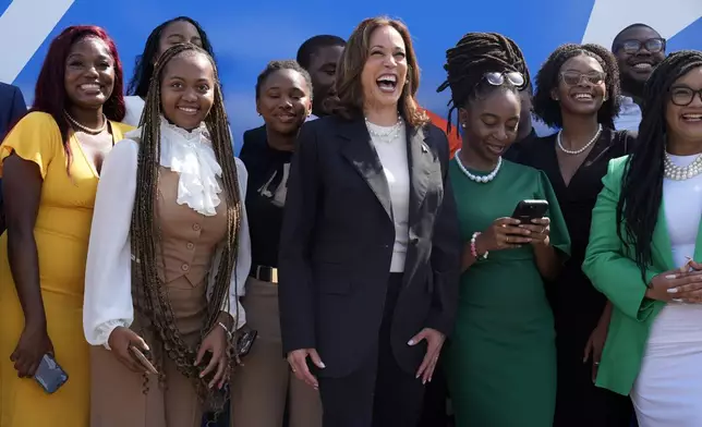 Democratic presidential nominee Vice President Kamala Harris pose for a photo with supporters at the Savannah/Hilton Head International Airport in Savannah, Ga., as before campaign events, Tuesday, Aug. 28, 2024. (AP Photo/Jacquelyn Martin)