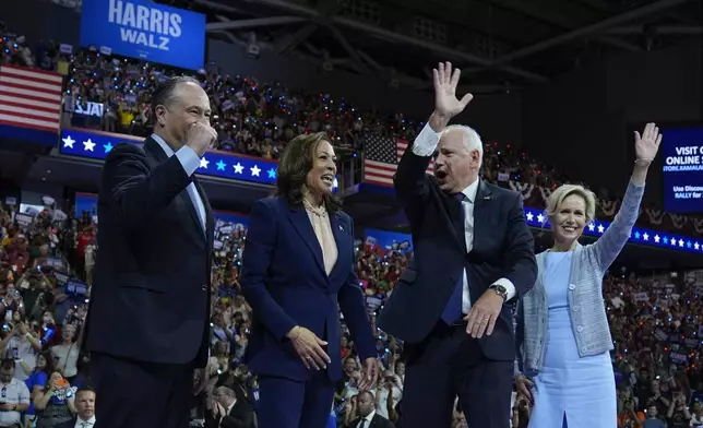 Democratic presidential nominee Vice President Kamala Harris and second gentleman Doug Emhoff along with her running mate Minnesota Gov. Tim Walz and his wife Gwen Walz appear at a campaign rally in Philadelphia, Tuesday, Aug. 6, 2024. (AP Photo/Matt Rourke)