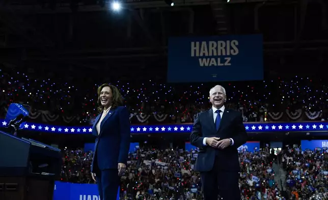 Democratic presidential nominee Vice President Kamala Harris and her running mate Minnesota Gov. Tim Walz arrive at a campaign rally in Philadelphia, Tuesday, Aug. 6, 2024. (AP Photo/Matt Rourke)