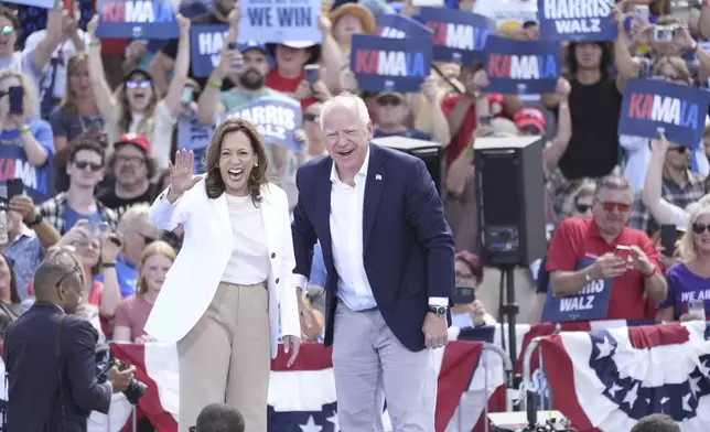 Democratic presidential nominee Vice President Kamala Harris is welcomed by Democratic vice presidential nominee Minnesota Gov. Tim Walz, before she delivers remarks at a campaign event, Wednesday, Aug. 7, 2024, in Eau Claire, Wisc. (AP Photo/Charles Rex Arbogast)