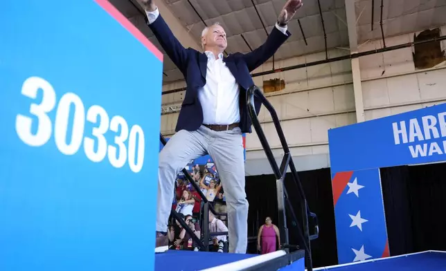 Democratic vice presidential candidate Minnesota Gov. Tim Walz arrives to speak at a campaign rally Wednesday, Aug. 7, 2024, in Romulus, Mich., before Democratic presidential nominee Vice President Kamala Harris. (AP Photo/Julia Nikhinson)