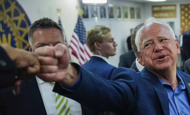 Democratic vice presidential nominee Minnesota Gov. Tim Walz fist bumps a supporter during a campaign rally at UAW Local 900, Thursday, Aug. 8, 2024, in Wayne, Mich. (AP Photo/Julia Nikhinson)