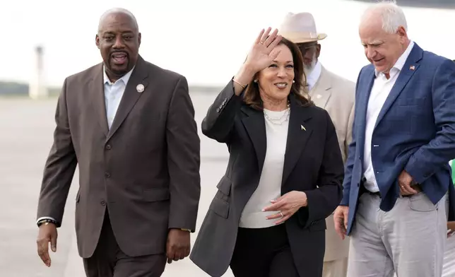 Democratic presidential nominee Vice President Kamala Harris and Democratic vice presidential candidate Minnesota Gov. Tim Walz walk with Savannah Mayor Van Johnson at the Savannah/Hilton Head International Airport in Savannah, Ga., as they arrive for campaign events, Wednesday, Aug. 28, 2024. (AP Photo/Jacquelyn Martin)