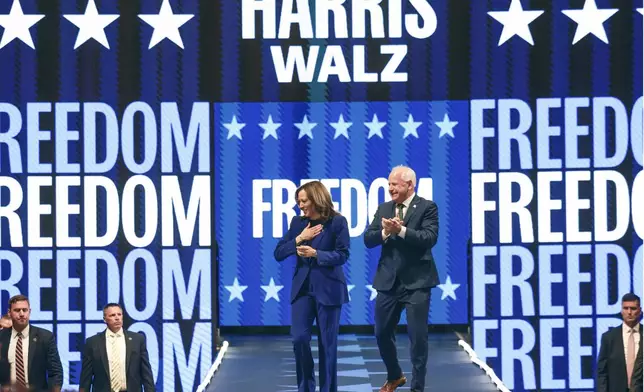 Democratic presidential nominee Vice President Kamala Harris and running mate Minnesota Gov. Tim Walz appear at the Fiserv Forum during a campaign rally in Milwaukee, Tuesday, Aug. 20, 2024. (AP Photo/Jeffrey Phelps)